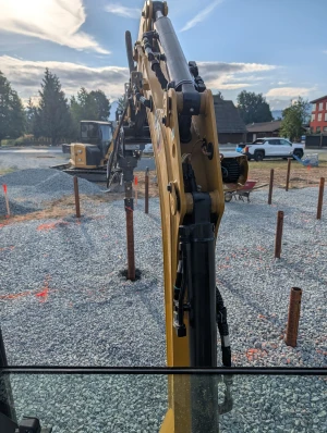 Office Building - Piles driven and marked on the gravel pad, drive head in the foreground