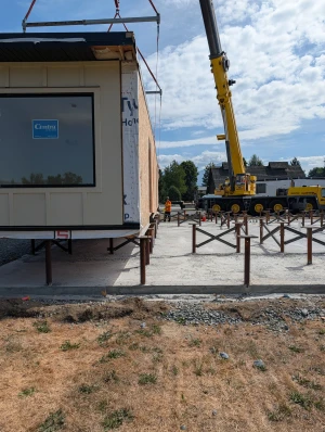 Office Building - First module lifted by crane over the pile frames