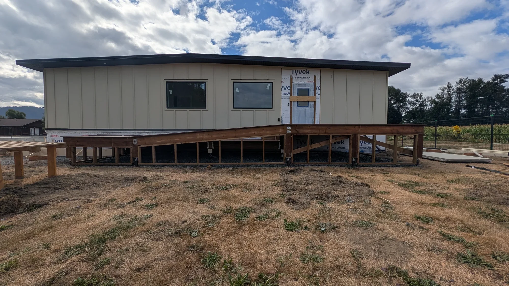 Office Building - Deck framing under way at the entrance, supported on piles