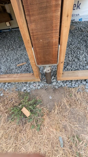 Office Building - Deck post bracket set on a pile in the gravel